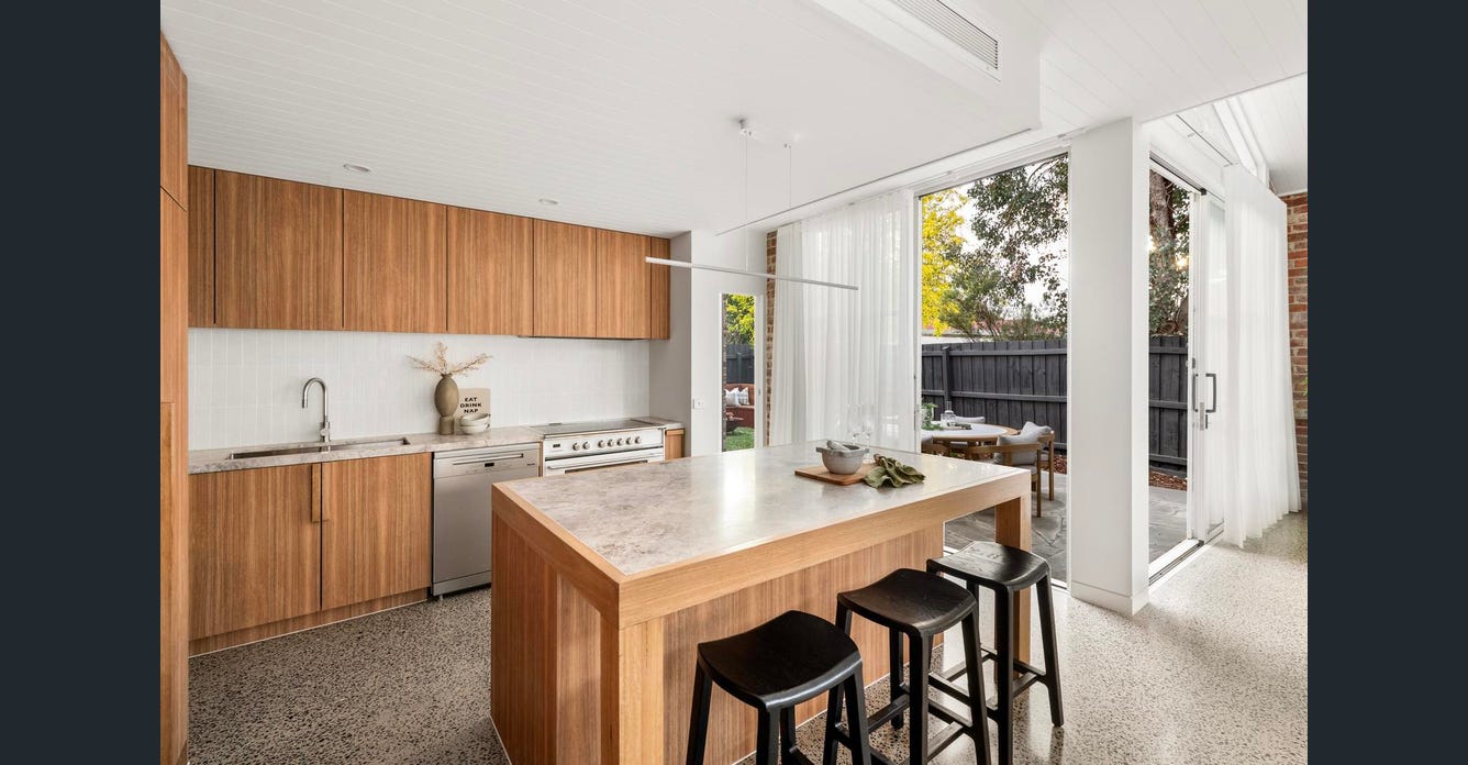 Union Street Brunswick timber kitchen with stone island bench and courtyard outlook