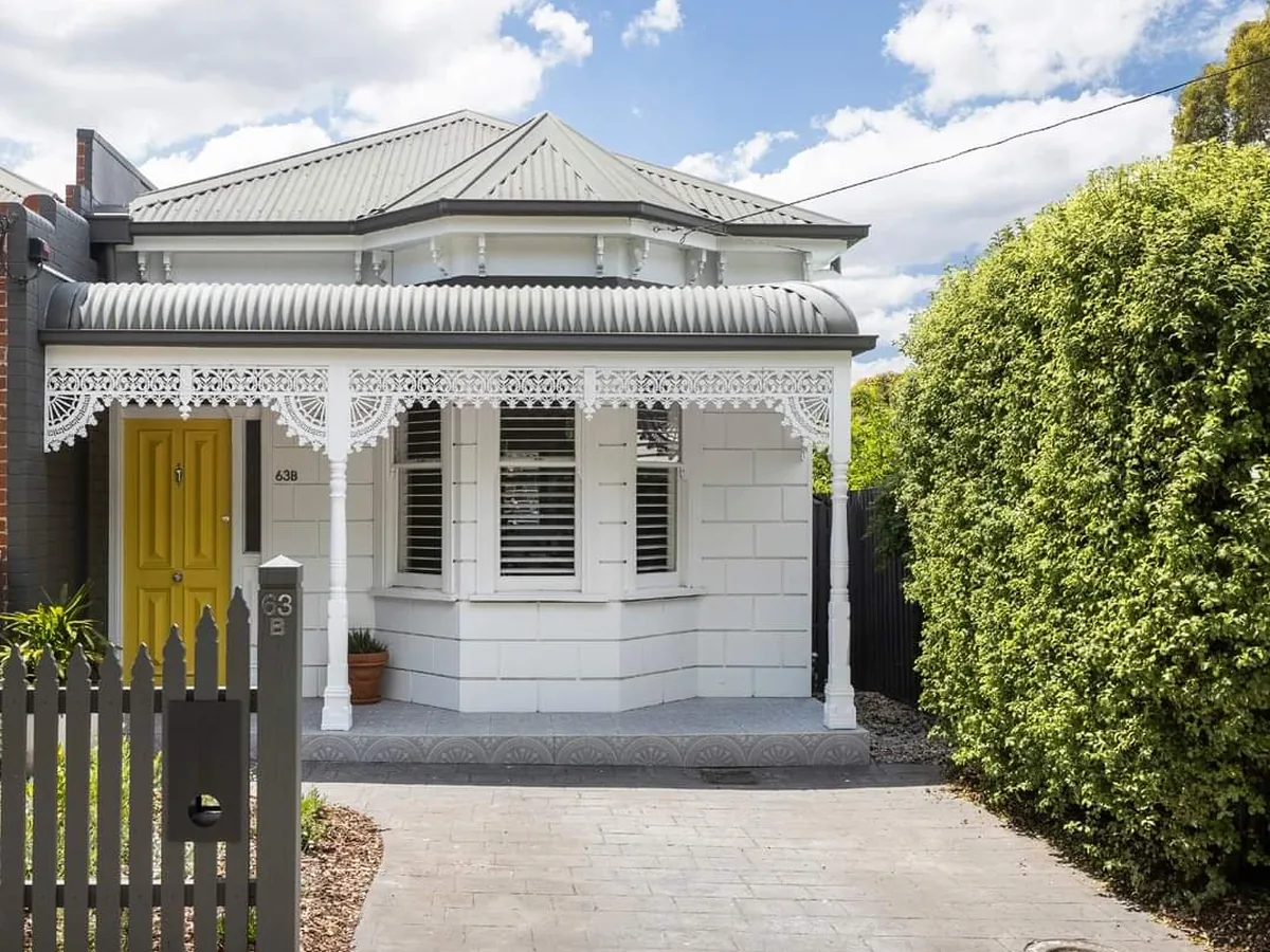 Clyde Street restored period facade with yellow door and iron lacework