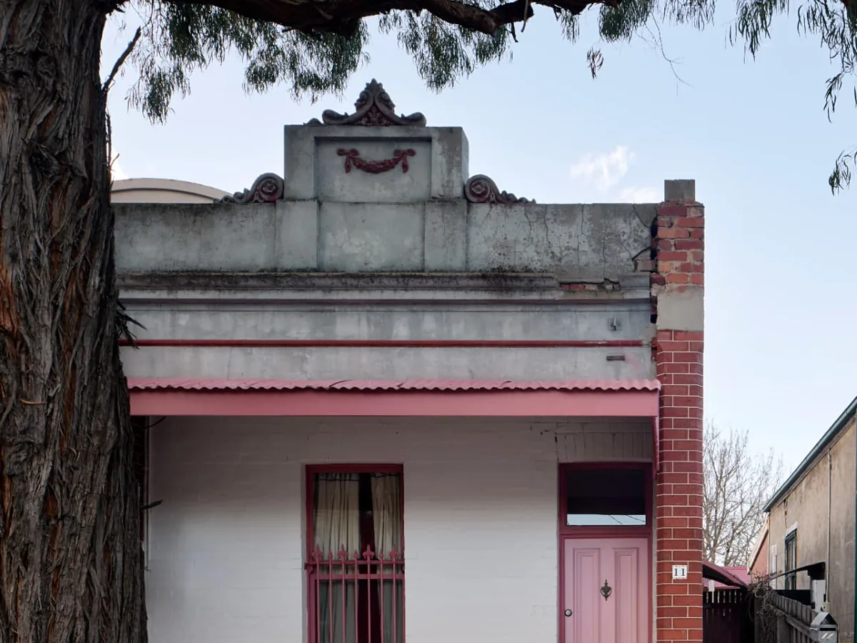 Finsbury Street Flemington heritage cottage facade with pink door and iron fence