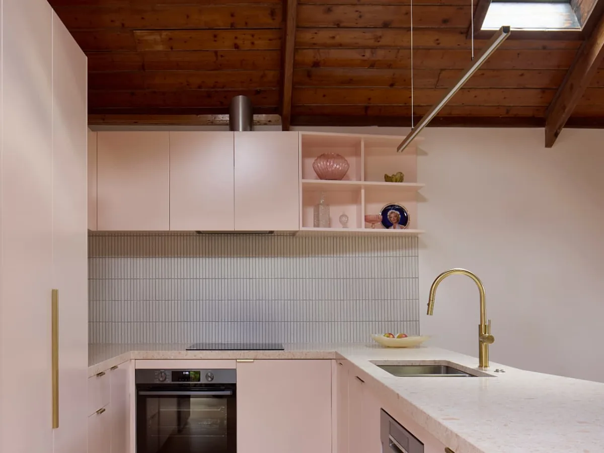 Finsbury Street pink kitchen joinery with terrazzo benchtop under timber ceiling