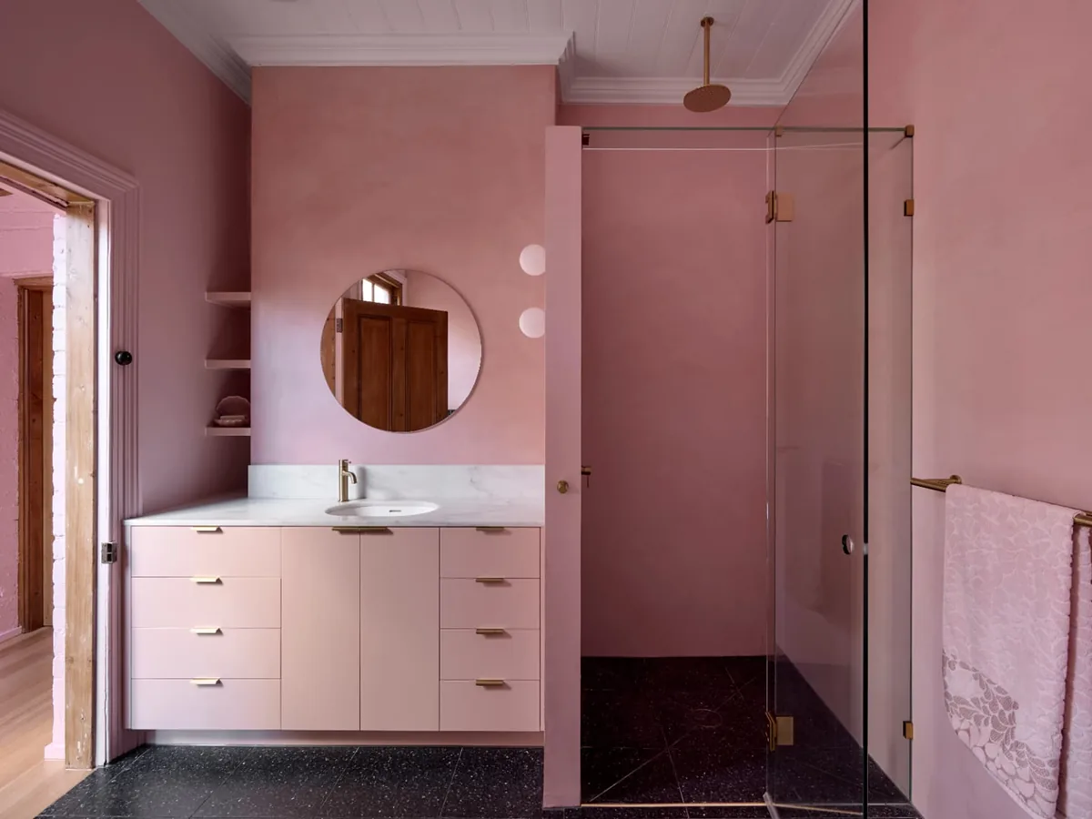 Finsbury Street pink bathroom with marble vanity, round mirror and walk-in shower