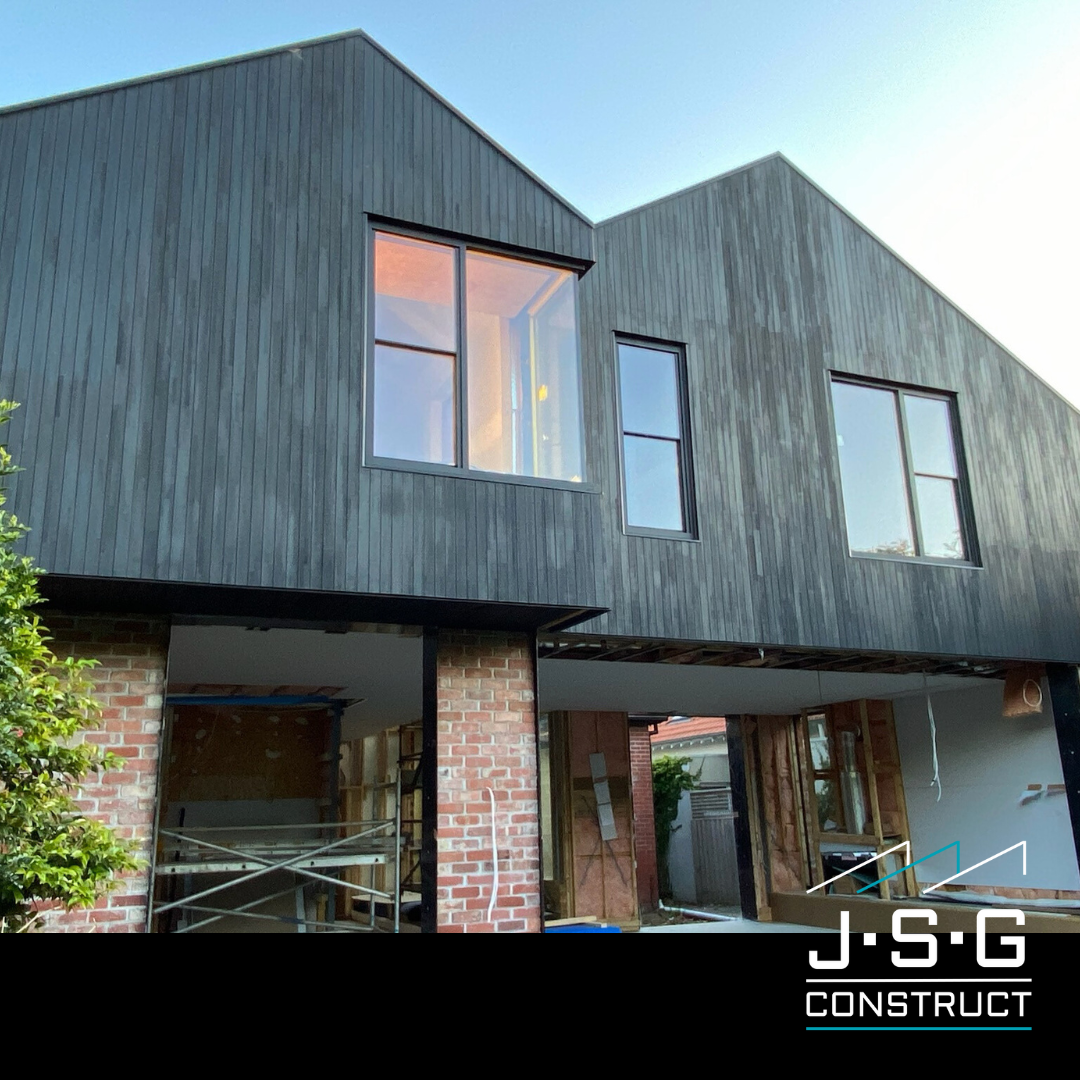 Contemporary home exterior by JSG Construct featuring dark cladding and modern design.