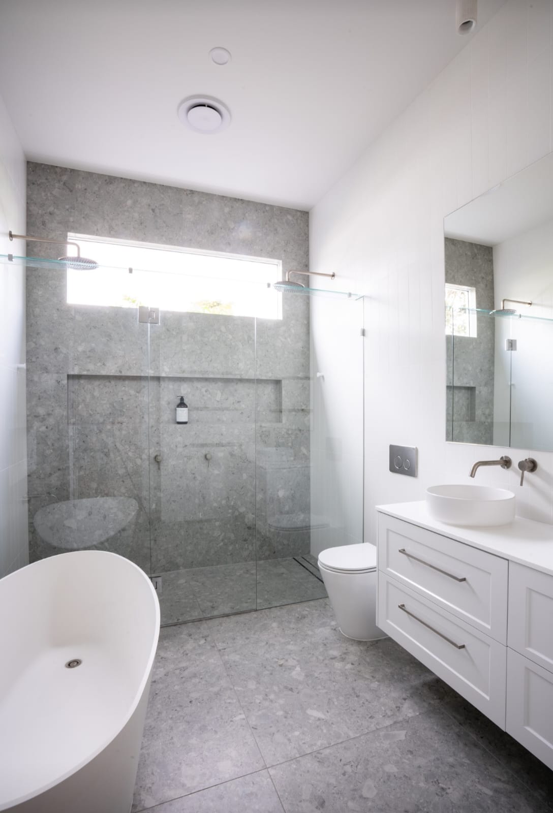 Sleek bathroom interior design with sophisticated fixtures by JSG Construct.